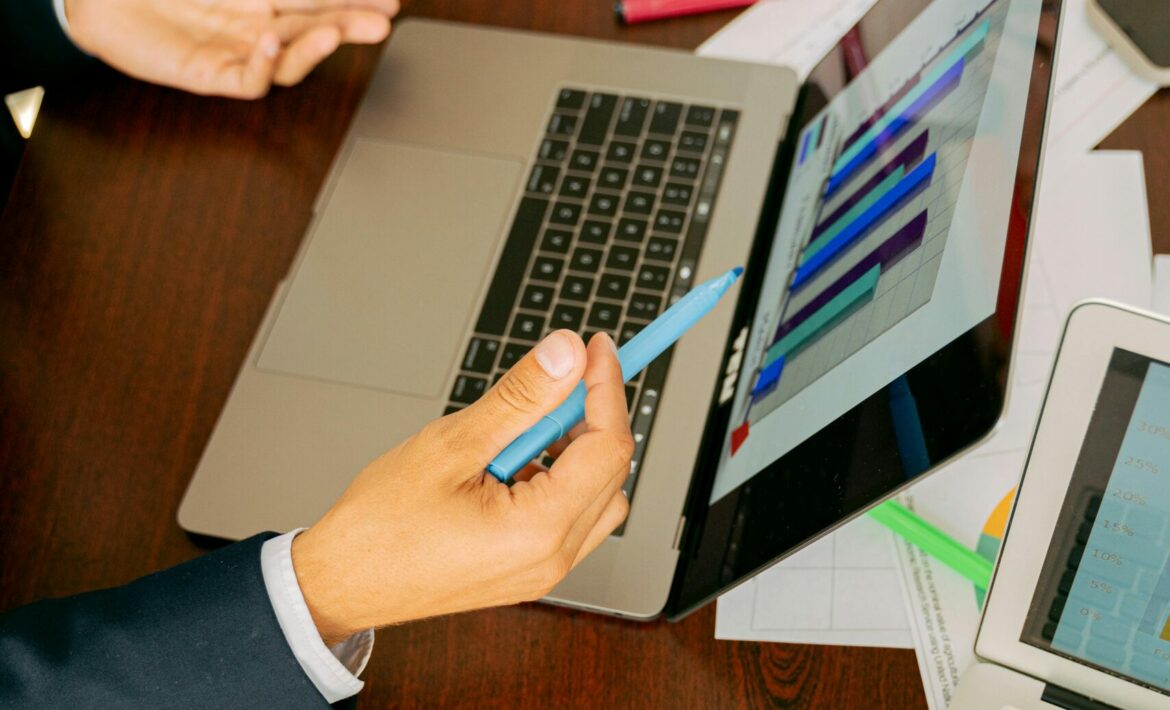 Free A Person in Black Suit Holding a Pen Stock Photo